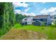 View of a beautiful backyard featuring lush green grass and a mix of blue and white siding at 2720 Spotted Coral Ct, Apex, NC 27502