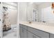 Modern bathroom with a shower/bath and gray vanity with a sleek countertop at 2720 Spotted Coral Ct, Apex, NC 27502