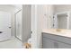 Well-lit bathroom featuring a modern glass shower and gray vanity with a sink at 2720 Spotted Coral Ct, Apex, NC 27502