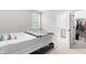 Bedroom with carpet, a black platform bed, and doorway to a bathroom and walk-in closet at 2720 Spotted Coral Ct, Apex, NC 27502
