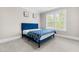 Cozy bedroom with a stylish blue bed and natural light at 2720 Spotted Coral Ct, Apex, NC 27502