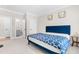 Comfortable bedroom featuring a plush blue bed and neutral walls at 2720 Spotted Coral Ct, Apex, NC 27502