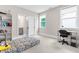 Bright bedroom with carpeted floors, two windows, a desk, and a bookcase at 2720 Spotted Coral Ct, Apex, NC 27502