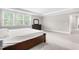 Bedroom featuring neutral walls, carpet, large window and a dark dresser at 2720 Spotted Coral Ct, Apex, NC 27502