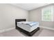 Clean and modern bedroom with carpet, white trim and a large window at 2720 Spotted Coral Ct, Apex, NC 27502