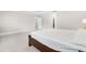 Bedroom with neutral walls, carpet, and doorway to bathroom and walk-in closet at 2720 Spotted Coral Ct, Apex, NC 27502