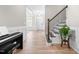 Inviting foyer with wood floors, a staircase, and ample natural light at 2720 Spotted Coral Ct, Apex, NC 27502
