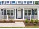Charming home with a white front door and covered porch, adorned with lovely landscaping at 2720 Spotted Coral Ct, Apex, NC 27502