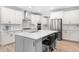 Kitchen boasts stainless appliances, a gray island with seating, and plenty of cabinet space at 2720 Spotted Coral Ct, Apex, NC 27502