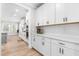 Bright kitchen features white cabinets, subway tile backsplash, and sleek hardware at 2720 Spotted Coral Ct, Apex, NC 27502