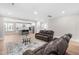 Bright living space with leather furniture, a fireplace, and an open kitchen at 2720 Spotted Coral Ct, Apex, NC 27502
