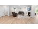 Spacious living room features a fireplace, mounted TV, hardwood floors, and leather seating at 2720 Spotted Coral Ct, Apex, NC 27502