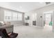 Spacious living room featuring a large window, a comfortable couch, and plush carpeting at 2720 Spotted Coral Ct, Apex, NC 27502