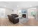 Spacious living room with a fireplace, plush sofas, and wood flooring at 2720 Spotted Coral Ct, Apex, NC 27502