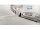 Comfortable living room featuring a couch, stairway, and neutral colored walls and carpet at 2720 Spotted Coral Ct, Apex, NC 27502