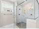 Glass enclosed shower with marble tile walls, and a handheld showerhead fixture at 2720 Spotted Coral Ct, Apex, NC 27502