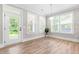 Sunroom with large windows, door to the outside, and hardwood flooring at 2720 Spotted Coral Ct, Apex, NC 27502