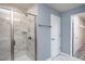 Bright bathroom with a tiled walk-in shower with glass door and linen closet in the background at 273 Broomside Ave, Raleigh, NC 27603