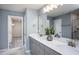 Modern bathroom featuring a double vanity with quartz countertops, undermount sinks and gray cabinets at 273 Broomside Ave, Raleigh, NC 27603
