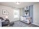 Cozy Bedroom featuring a crib, rocking chair, and stylish decor and a large sunlit window at 273 Broomside Ave, Raleigh, NC 27603