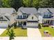 Aerial view of a charming two-story home with a well-manicured lawn, and beautiful landscaping at 3057 Eden Harbor Ct, Raleigh, NC 27613