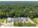 An aerial view of a neighborhood showcases contemporary homes and tree coverage at 3057 Eden Harbor Ct, Raleigh, NC 27613