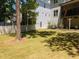 Spacious backyard featuring lush green grass, mature trees, and a privacy fence, perfect for outdoor activities at 3057 Eden Harbor Ct, Raleigh, NC 27613