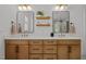 Modern bathroom featuring double vanity, quartz countertops, stylish fixtures, and decorative floating shelves at 3057 Eden Harbor Ct, Raleigh, NC 27613
