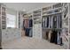 Spacious walk-in closet with custom shelving, drawers, and ample hanging space for organized storage at 3057 Eden Harbor Ct, Raleigh, NC 27613
