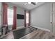 Well-lit exercise room with gray walls, wood floors, and simple exercise equipment, ideal for home workouts at 3057 Eden Harbor Ct, Raleigh, NC 27613