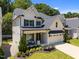 Beautifully landscaped two-story home with a welcoming front porch and attached two-car garage at 3057 Eden Harbor Ct, Raleigh, NC 27613