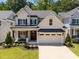 Charming two-story home showcasing a welcoming front porch and well-manicured landscaping at 3057 Eden Harbor Ct, Raleigh, NC 27613