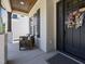 Charming porch with seating, complemented by a stylish front door and decorative wreath at 3057 Eden Harbor Ct, Raleigh, NC 27613