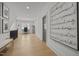 Spacious hallway with wood floors, large artwork, and a glimpse of the office space, adding character at 3057 Eden Harbor Ct, Raleigh, NC 27613