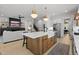 Open-concept kitchen with a large island connecting to a cozy living space at 3057 Eden Harbor Ct, Raleigh, NC 27613