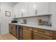 Kitchenette features custom cabinets, a mini fridge, sleek countertops, tile backsplash, and stainless steel appliances at 3057 Eden Harbor Ct, Raleigh, NC 27613