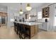 Open kitchen featuring a sizable island with seating, white cabinets, and hardwood floors at 3057 Eden Harbor Ct, Raleigh, NC 27613