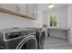 Well-equipped laundry room with modern appliances, ample counter space, and stylish tile flooring at 3057 Eden Harbor Ct, Raleigh, NC 27613