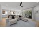 Open concept living room flows to the kitchen, complete with a large sectional and a view of the outdoor patio at 3057 Eden Harbor Ct, Raleigh, NC 27613