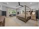 Inviting main bedroom with wood-frame bed, neutral decor, and large windows for a serene retreat at 3057 Eden Harbor Ct, Raleigh, NC 27613