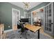 Bright office space with olive green walls, a modern light fixture, and glass French doors to other rooms at 3057 Eden Harbor Ct, Raleigh, NC 27613