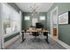 Office room with green walls, two windows, a wood desk, and a modern lighting fixture at 3057 Eden Harbor Ct, Raleigh, NC 27613