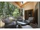 Relaxing screened porch with comfortable seating, overhead lights, and serene view of surrounding greenery at 3057 Eden Harbor Ct, Raleigh, NC 27613