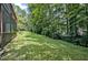 Large backyard showing the home exterior with mature trees, and well maintained lawn at 311 Westbrook Dr, Carrboro, NC 27510