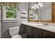 Nicely remodeled bathroom with a new vanity, mirror, and fixtures next to a large window at 311 Westbrook Dr, Carrboro, NC 27510