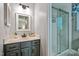 Bathroom with vanity, framed mirror, and glass shower with white subway tile at 311 Westbrook Dr, Carrboro, NC 27510