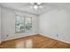 Minimalist bedroom design with hardwood floors, ceiling fan, and well-lit window at 311 Westbrook Dr, Carrboro, NC 27510