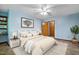 Stylishly furnished bedroom with blue walls, decor, ceiling fan, and plenty of natural light at 311 Westbrook Dr, Carrboro, NC 27510