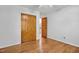 Well-lit bedroom with hardwood floors, ceiling fan, and large closet with open door at 311 Westbrook Dr, Carrboro, NC 27510