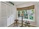 Bright breakfast nook featuring two stools, a bistro table, and bay window with natural light at 311 Westbrook Dr, Carrboro, NC 27510